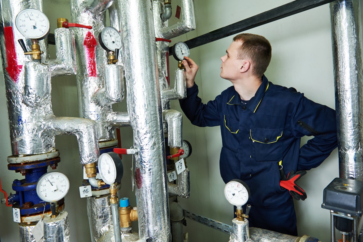 Repairman inspecting refrigerant